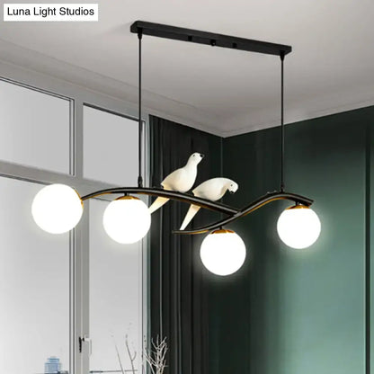 DecorBites™ modern black metal dining room island light pendant with three white glass bulbs, sculpted birds, and adjustable cord length