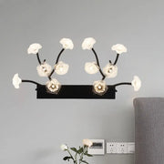 Modern black metal wall light with delicate white blossom clear glass fixtures for stylish bedroom decor
