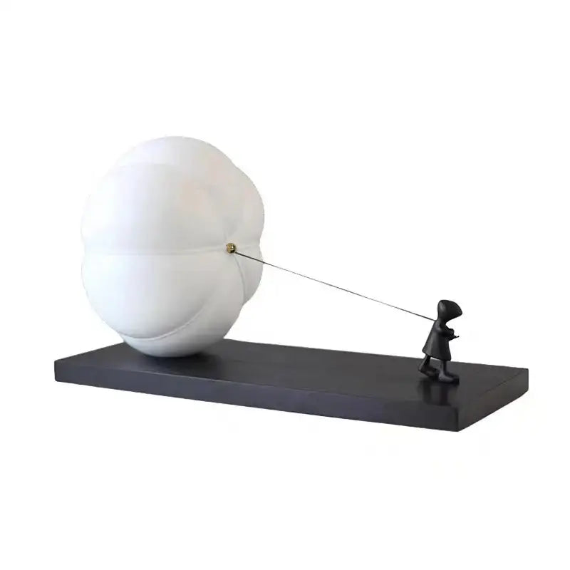 White glossy ceramic cartoon balloon man sculpture of child pulling cloud string for modern living room decor