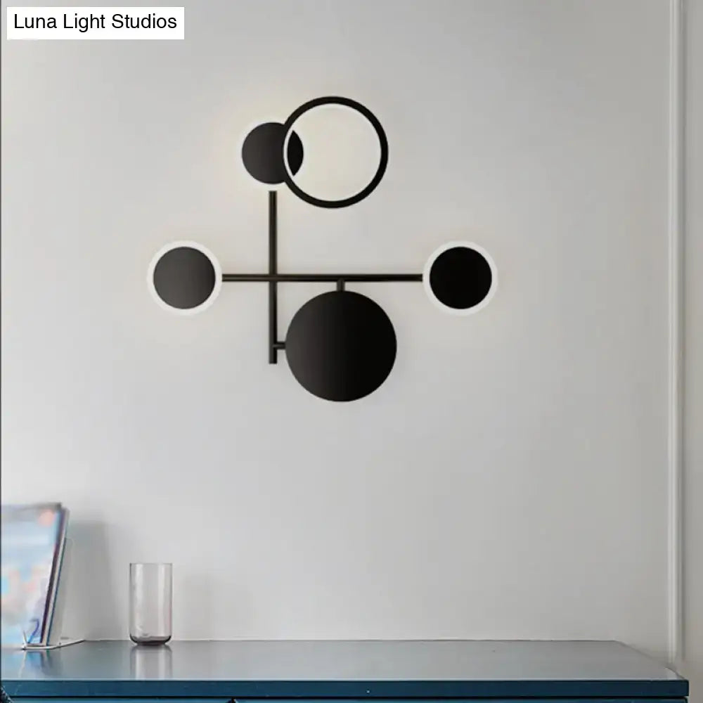 Modern black and white metallic round led wall sconce with minimalist geometric design for living room lighting