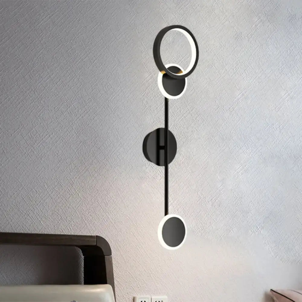 Modern black and white metallic round led wall sconce with sleek minimalist design for living room lighting