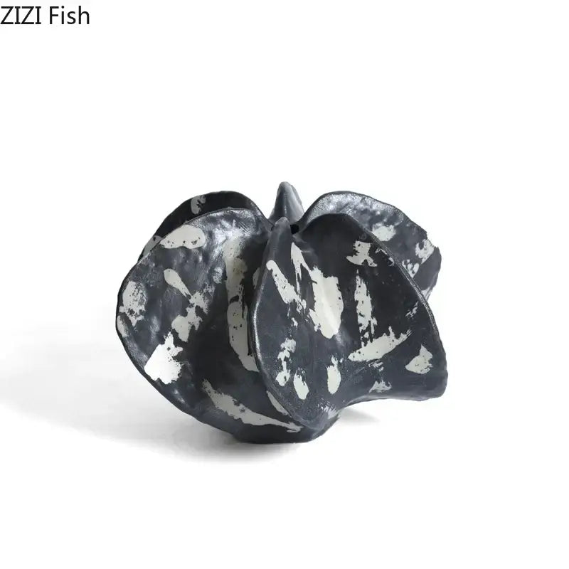 Modern black and white ceramic starfruit coral sculpture with organic leaf-like folds for bedroom decor