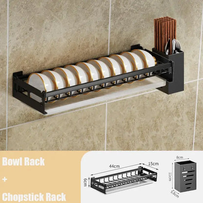 Modern black metal wall-mounted dish drainer rack with two tiers holding white plates with gold rims for kitchen storage