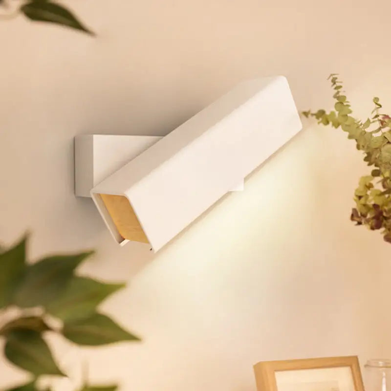 White rectangular wall-mounted led sconce lamp with sleek modern design and warm-toned interior lining for bedroom use