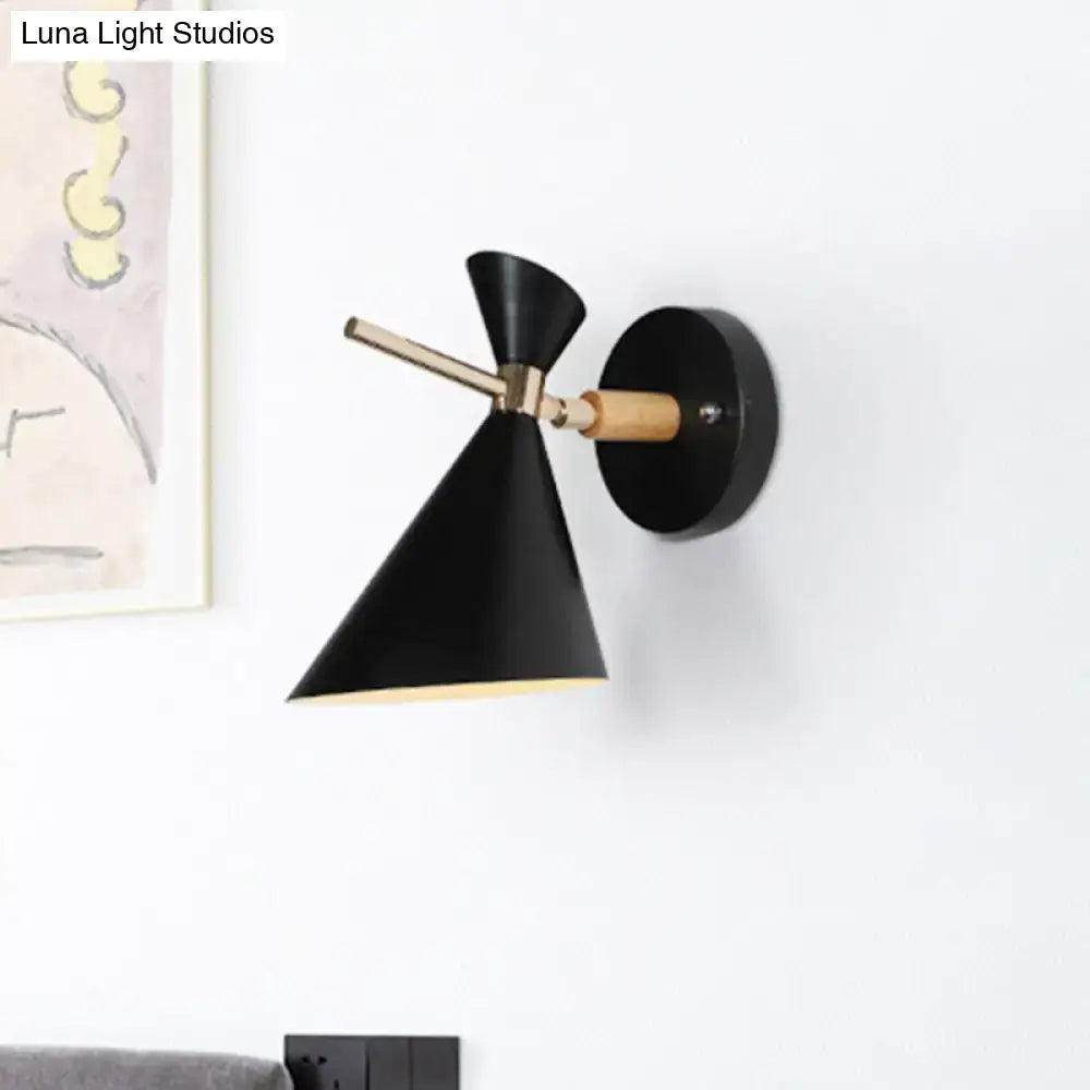 Modern black angle shade wall sconce with brass arm and wooden accent ideal for bedroom lighting