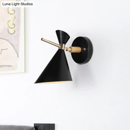 Modern black angle shade wall sconce with brass arm and wooden accent ideal for bedroom lighting