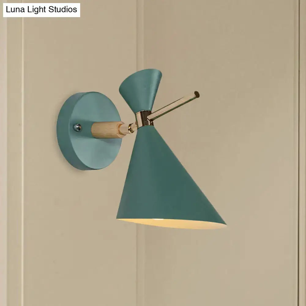 Teal wall sconce with wooden arm and conical angle shade designed as a modern bedroom light fixture