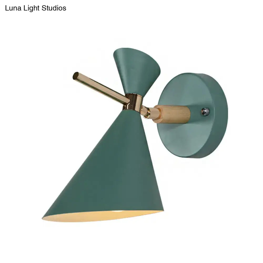 Modern wall sconce with teal conical angle shade, brass accents, and wooden mounting detail for bedroom lighting
