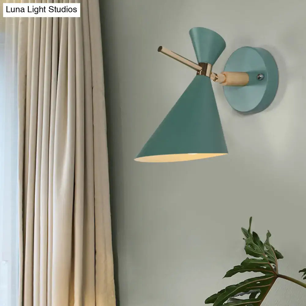 Teal conical wall sconce with brass and wood accent arm featuring a modern black angle shade for bedroom lighting