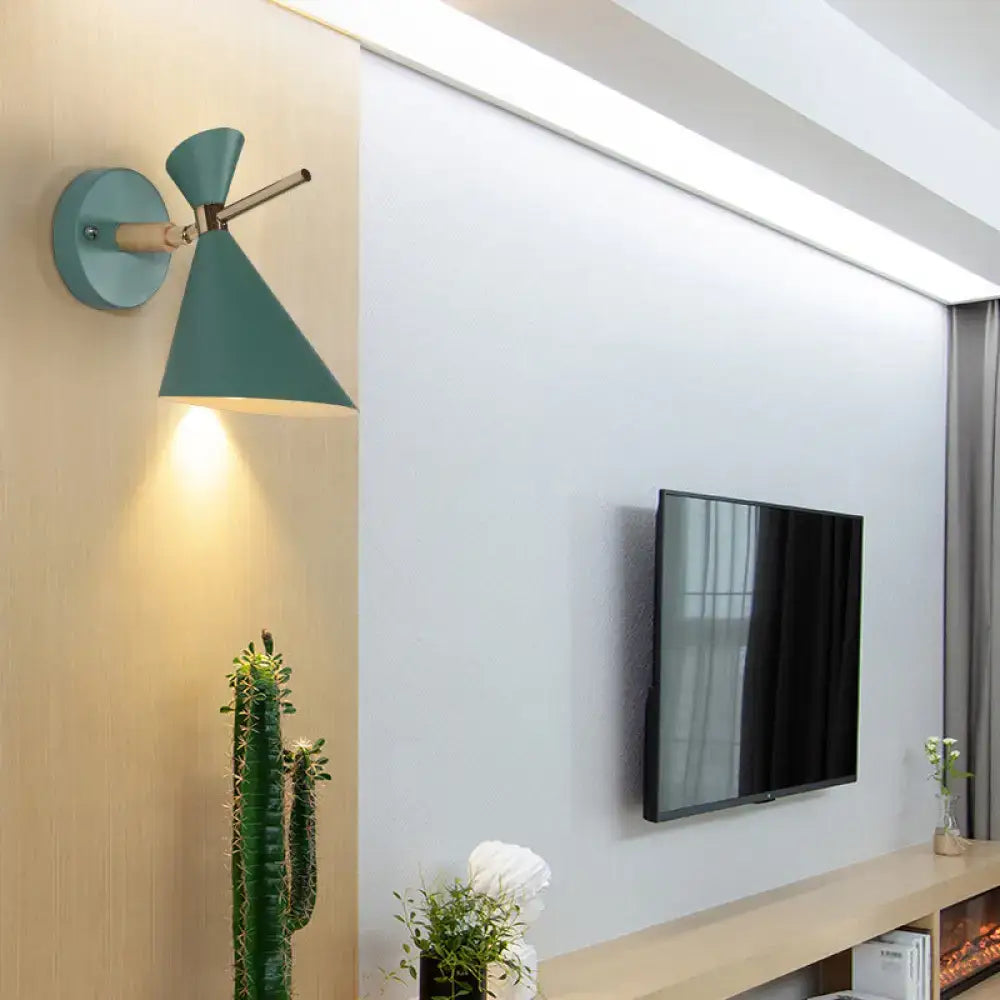 Modern wall sconce with teal conical angle shade and brass finished arm for bedroom lighting