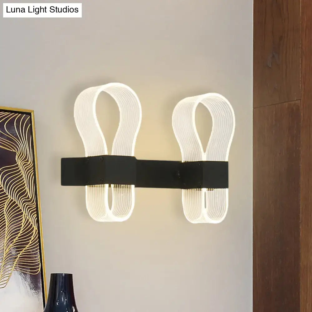 Modern black arc ring sconce wall lamp with sleek ribbon-like illuminated led arms for contemporary bedroom lighting