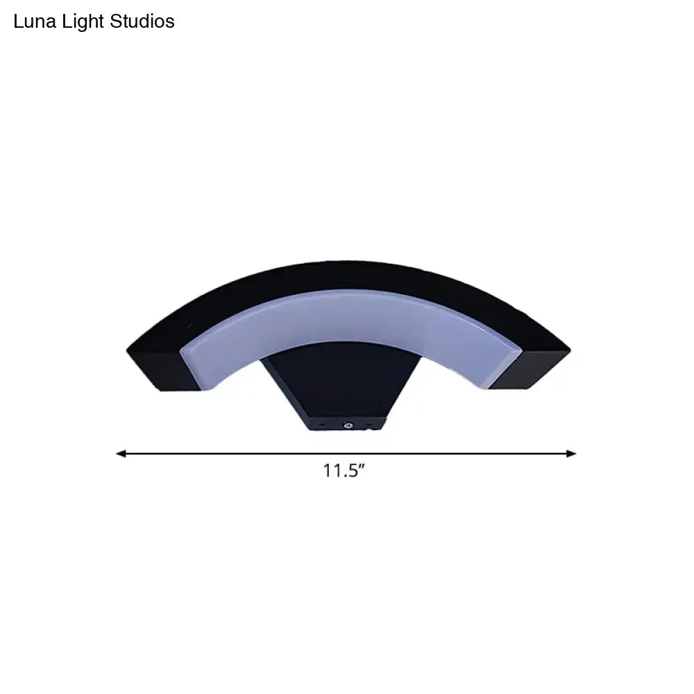 Modern black arc wall sconce with a sleek curved design and integrated soft white led light for bedroom use