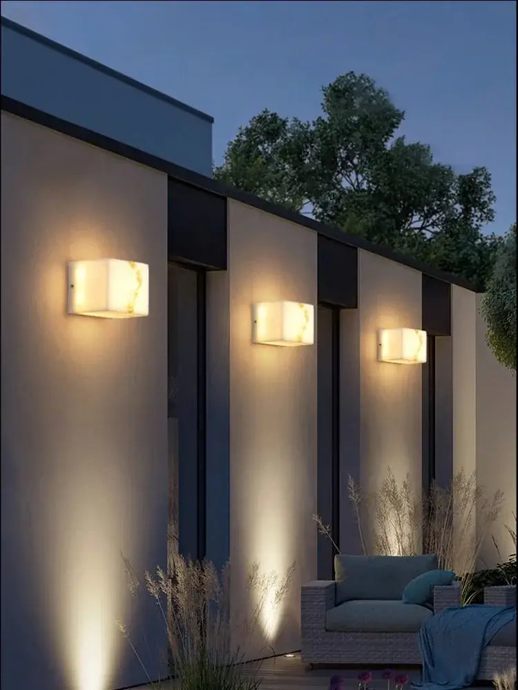 Modern black art deco marble led wall light with warm glowing alabaster like shade for bedroom decorbites art deco