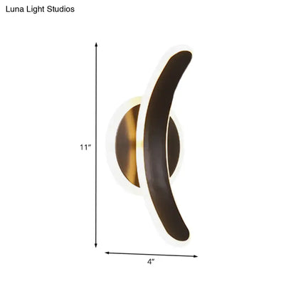 Modern crescent-shaped wall mounted lamp with brushed brass base and dark bronze arm providing white warm light