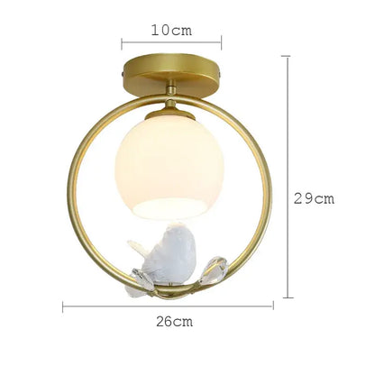 Modern black bird ceiling light fixture with gold-toned circular frame frosted globe and white ceramic bird on crystal accents