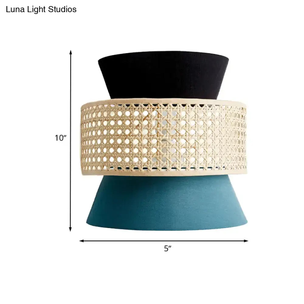 Modern black and blue rattan dual cone wall lamp featuring a three-tiered black, cream cane, and teal design