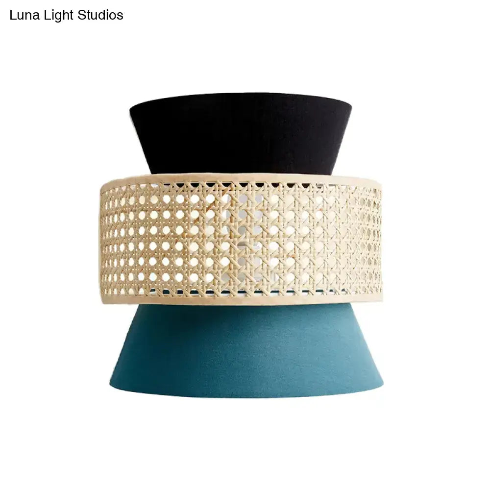 Modern black and blue rattan dual cone wall lamp featuring a black and teal cone with woven cane middle section