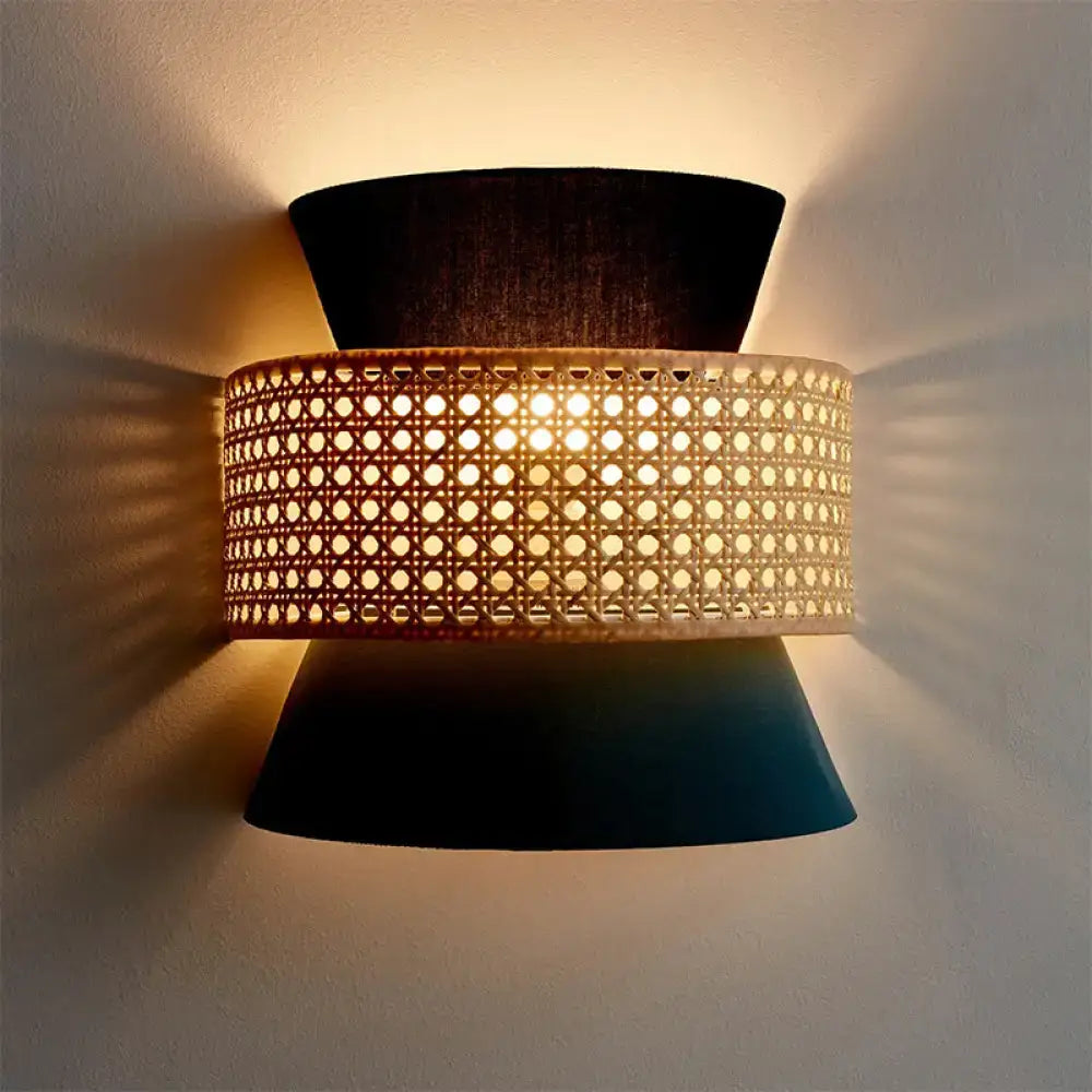 A modern black and blue dual cone wall lamp with woven cane middle section and dark tapered fabric shades