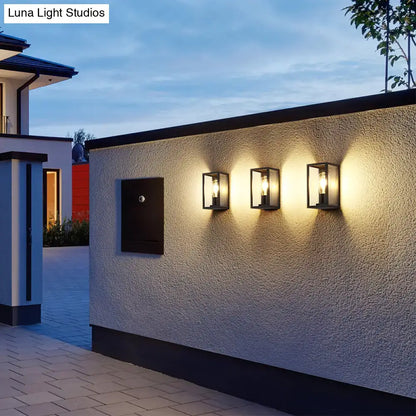 Three black-framed rectangular wall sconces with clear glass and filament bulbs for modern box patio wall lighting