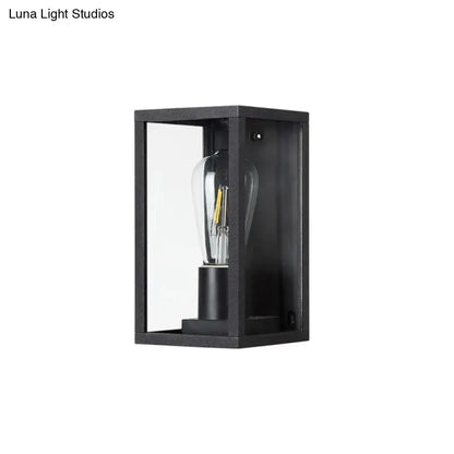 Modern black box patio wall sconce with clear glass panels and visible filament bulb for outdoor lighting