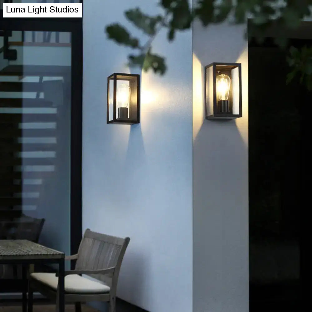 Modern black box patio wall sconce with rectangular glass panels and exposed filament bulbs for outdoor lighting