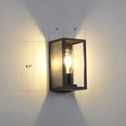 Modern black metal rectangular wall sconce with clear glass panels and exposed filament bulb for box patio wall lighting