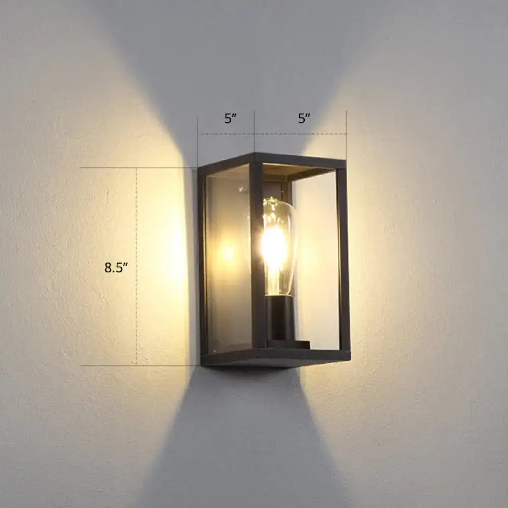 Modern black metal rectangular wall sconce with clear glass panels and exposed filament bulb for box patio wall lighting