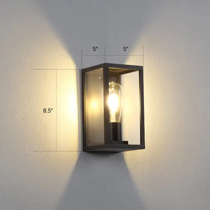 Modern black metal rectangular wall sconce with clear glass panels and exposed filament bulb for box patio wall lighting