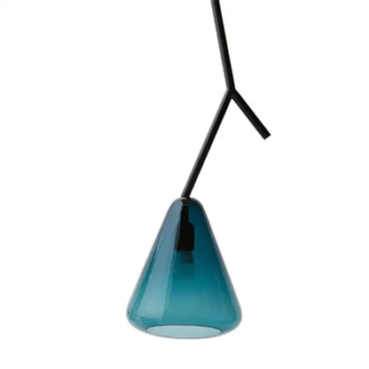 A sleek translucent teal glass pendant light with a black metal y-shaped suspension arm for modern dining rooms