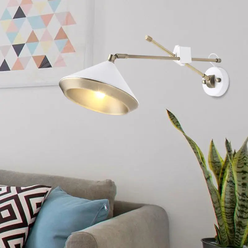 Modern black and brass wall light with adjustable arm and white conical shade featuring a brass bulb base