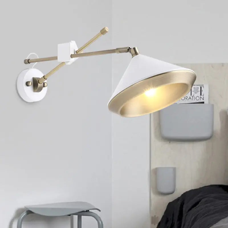 White and brass adjustable arm wall light with conical shade and bulb base ideal for modern bedroom sconces