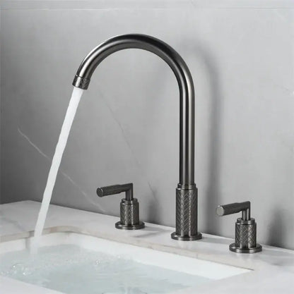 Modern black brass basin faucet with textured diamond-patterned handles mounted on white marble sink decorbites black brass