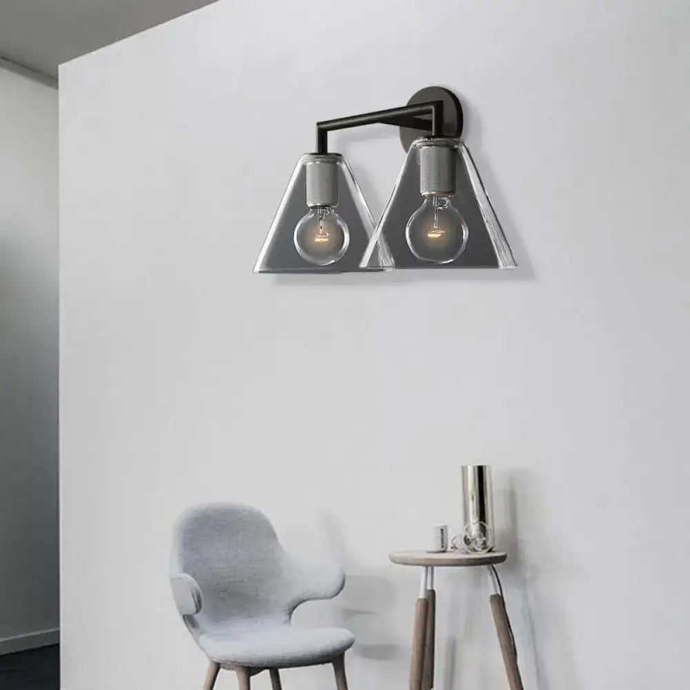 Modern black metal wall light with brass glass cone shades and direct wired electric installation for bedroom use