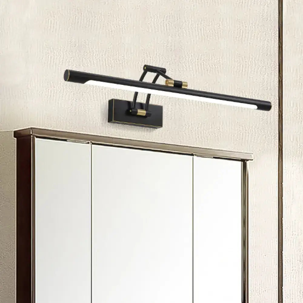 Modern black and brass led vanity light with sleek minimalist design mounted above a linear mirror cabinet