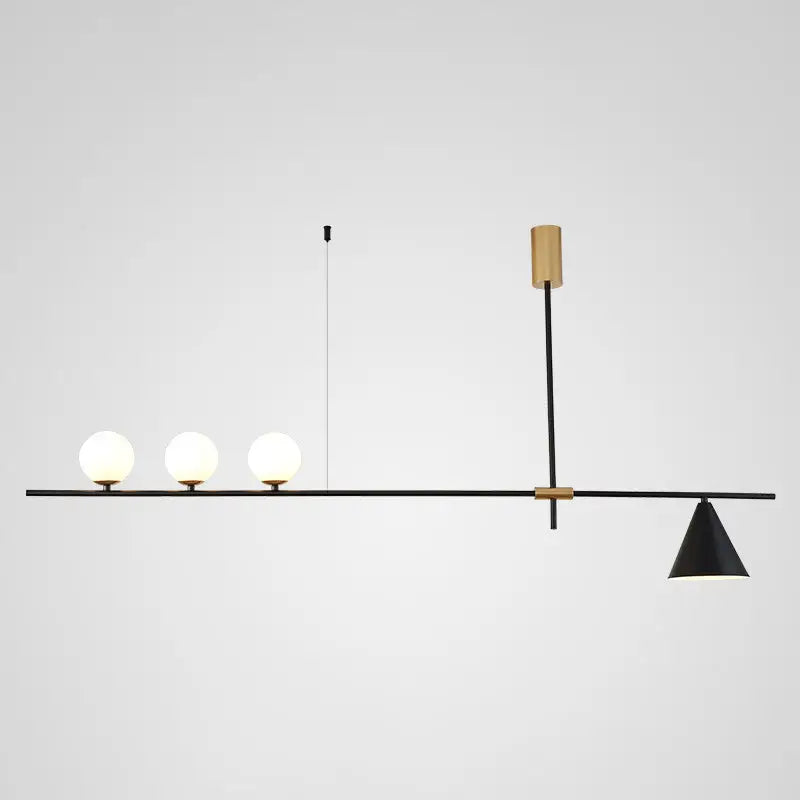 Modern black and brass linear chandelier with three spherical white glass bulbs and a conical shade for dining room