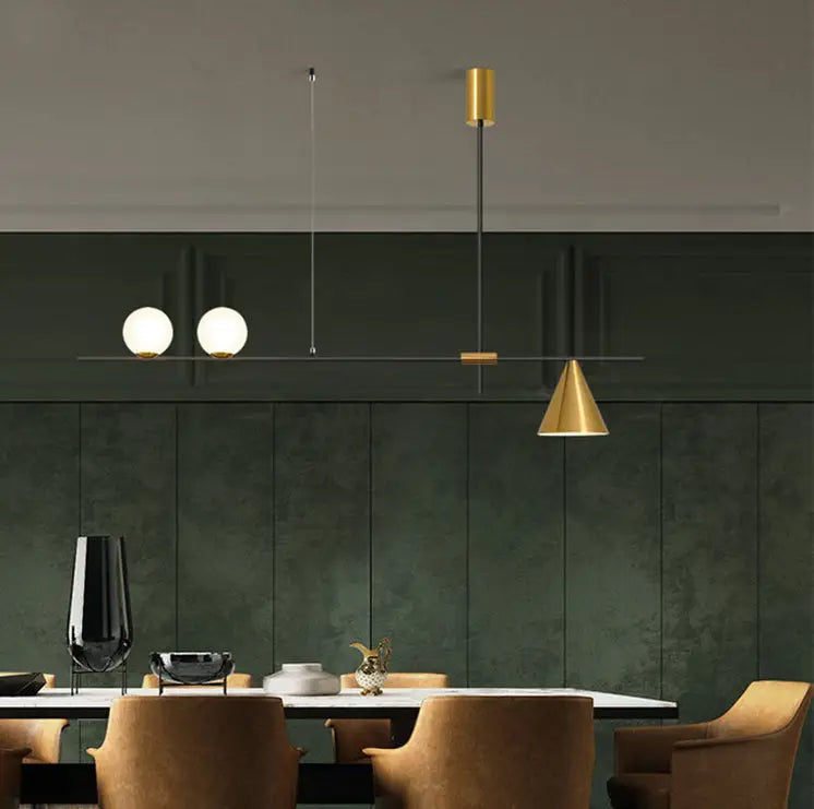 Modern black and brass linear chandelier with gold-toned fixture and spherical white glass bulbs for dining room use