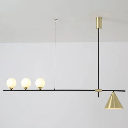 Modern black and brass linear chandelier with spherical white glass bulbs and a conical brass shade for dining room use