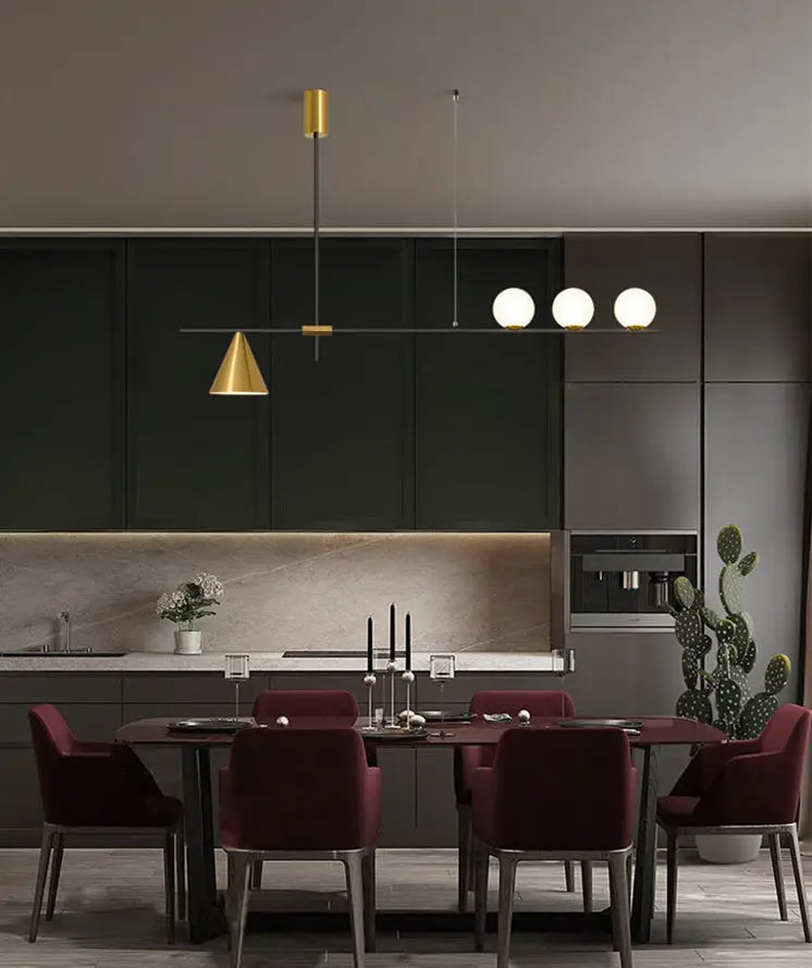 Modern black and brass linear chandelier with gold metal frame and spherical white glass bulbs for dining room lighting