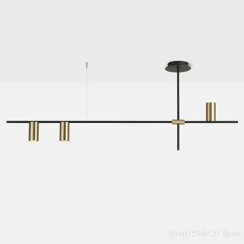Modern black and brass minimalist linear pendant light with cylindrical fixtures for black minimalist dining decorbites