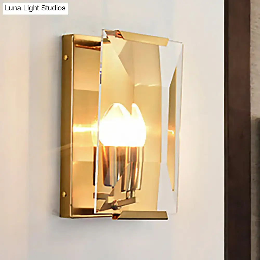 Modern black brass sconce light with gold-toned finish, clear geometric acrylic shade, and exposed brass hardware for bedroom