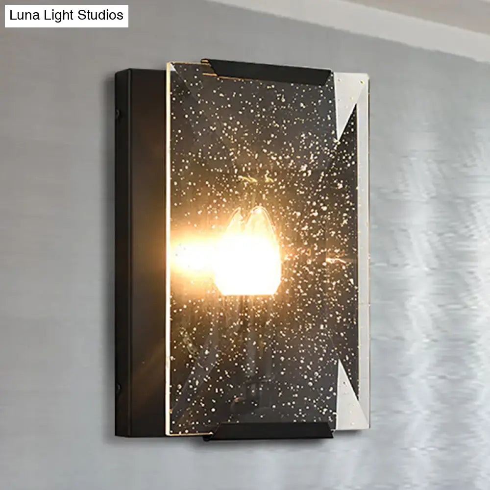 Modern black brass finish sconce light with silver frame and starry speckled glass panel for bedroom wall decor