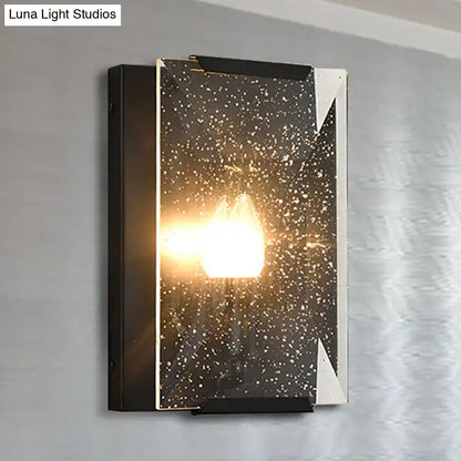 Modern black brass finish sconce light with silver frame and starry speckled glass panel for bedroom wall decor