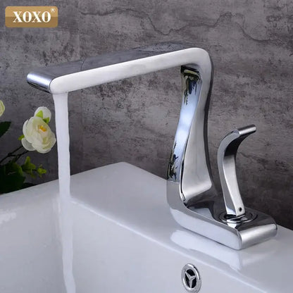 Modern black brass basin faucet with chrome finish single handle and sleek curved waterfall design by decorbites