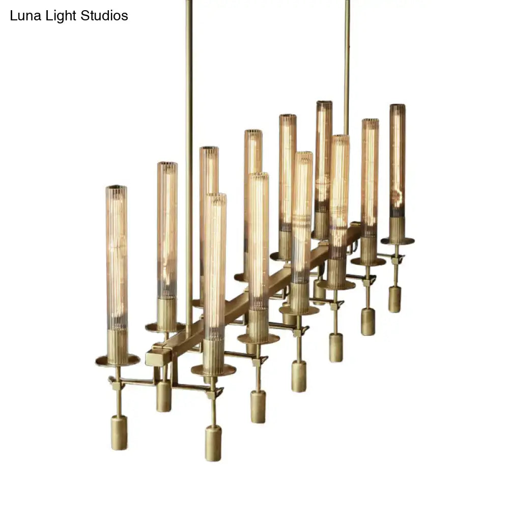 Brass-toned tube island chandelier with black brass finish and cylindrical glass tubes featuring exposed filament bulbs