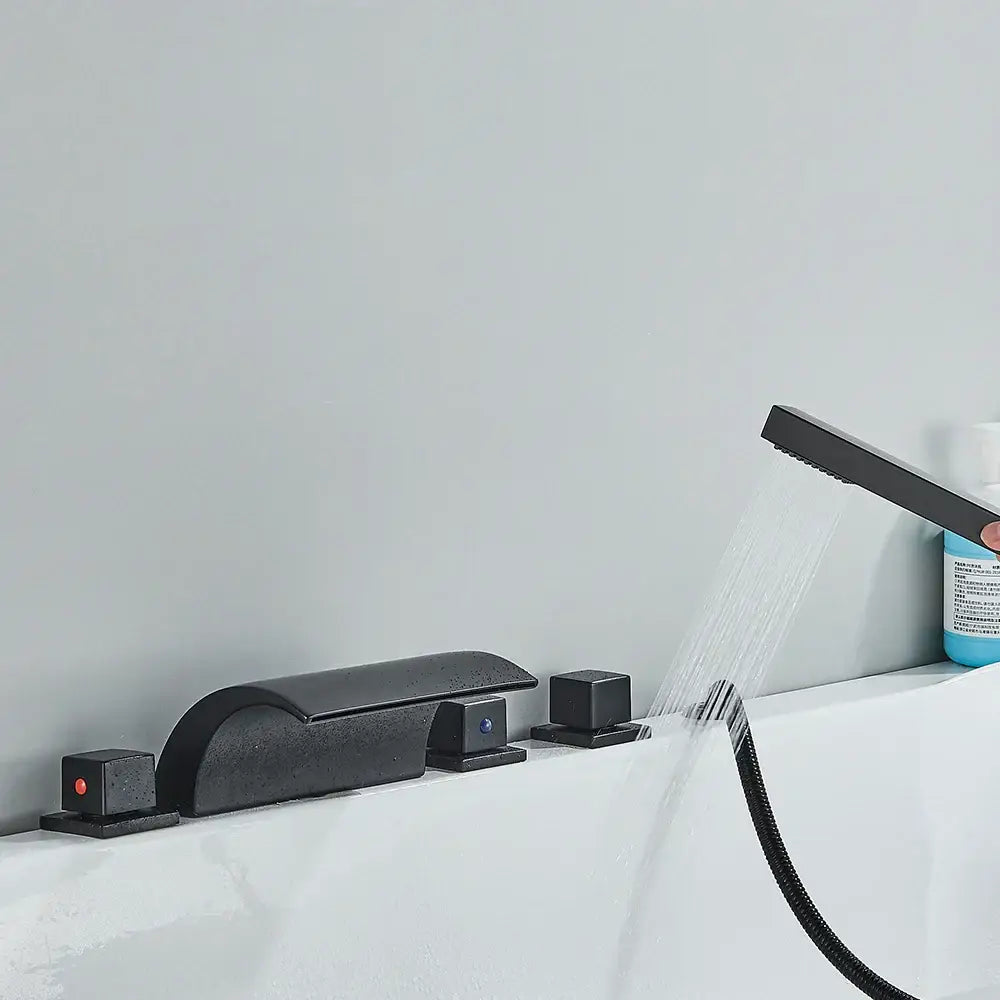 Modern black brass waterfall tub faucet with integrated controls and handheld showerhead in matte finish