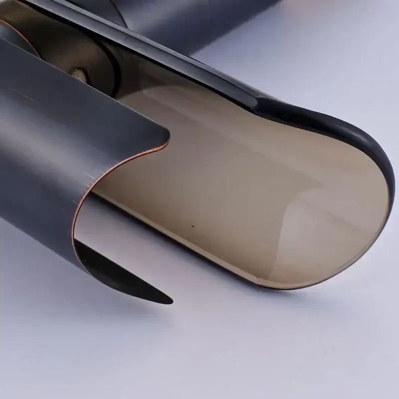 Modern black bronze glass waterfall tap shown with a black-framed translucent amber glass eyeglass case accessory