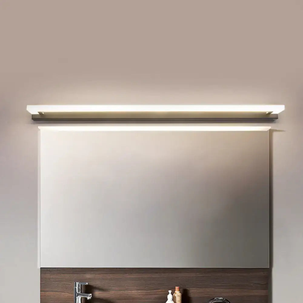 Modern black and brushed brass led bathroom light with sleek rectangular design and warm white light illumination