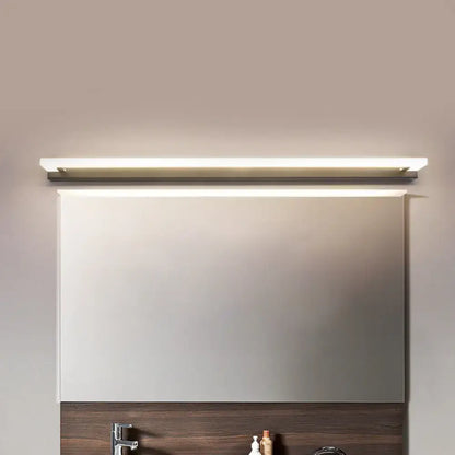 Modern black and brushed brass led bathroom light with sleek rectangular design and warm white light illumination