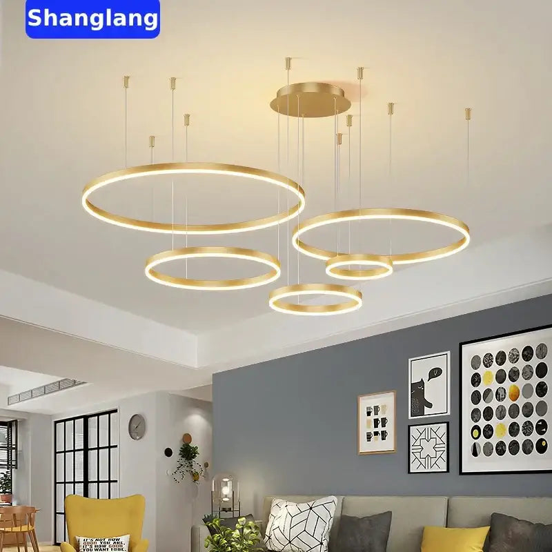 Modern gold-finished circular rings led chandelier with multiple rings suspended at varying heights for living room decorbites brushed rings