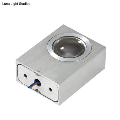 Silver rectangular led lighting piece with circular lens and visible wiring in brushed silver rgb wall fixture for corridor